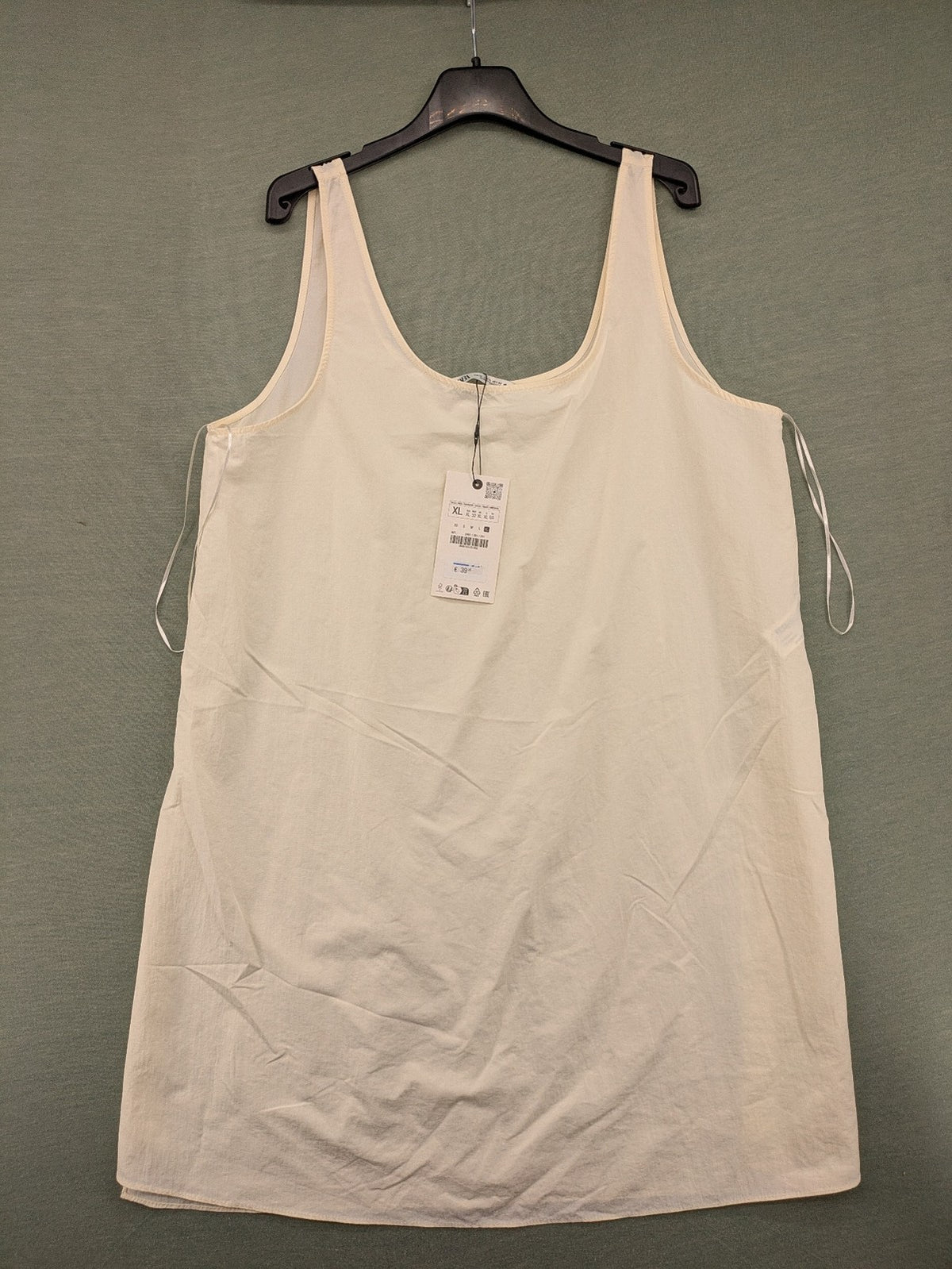 Zara cream tank top, sleeveless design, smooth polyamide fabric, minimalist style.