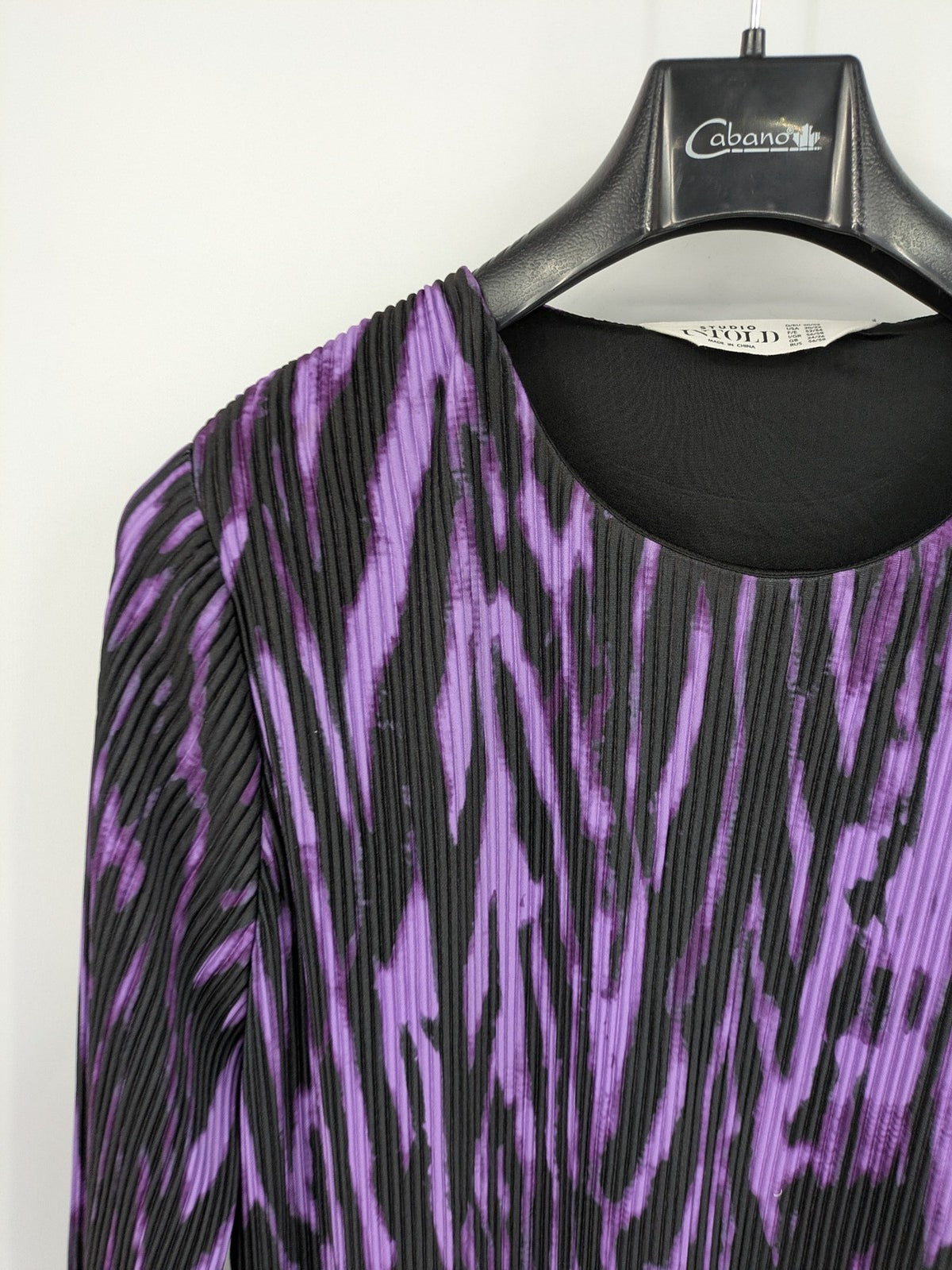 Untold black and purple pleated dress with animal print pattern and long sleeves.