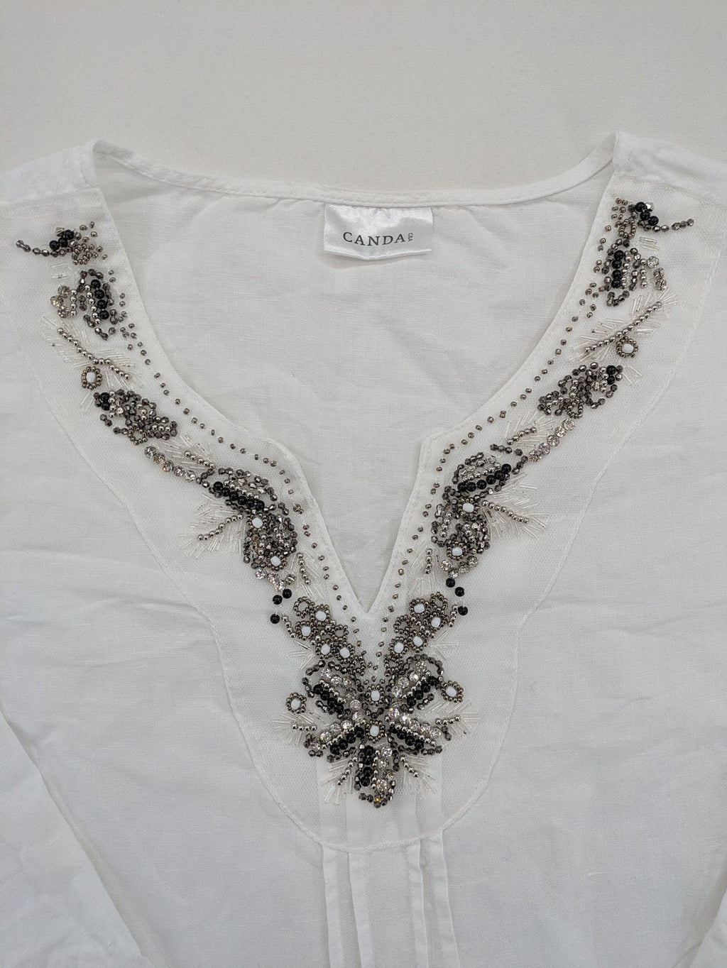 Canda white tunic top with embroidered V-neck, pearl and sequin details, 3/4 sleeves.
