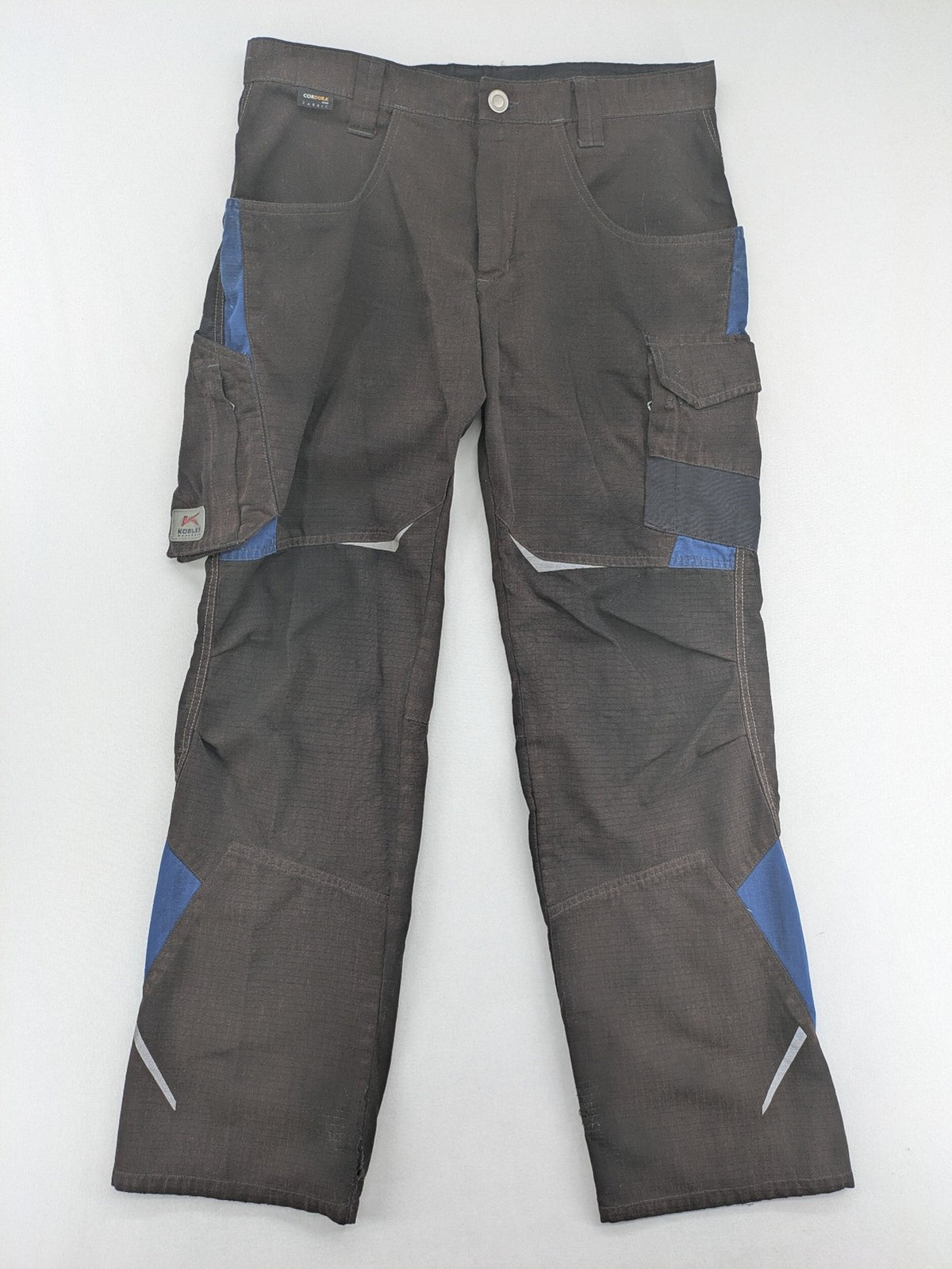 Kübler work pants blue grey Cordura fabric with multiple cargo pockets and reflective details.
