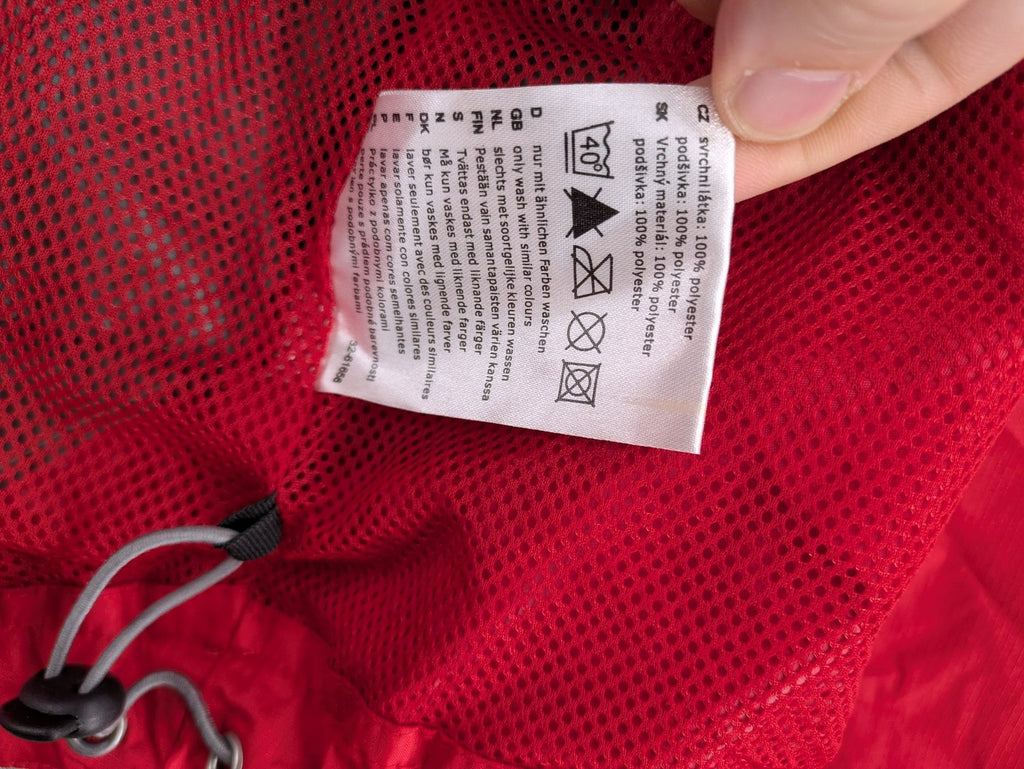 Movement Session grey and red windbreaker jacket with colorblock pattern and full zip.