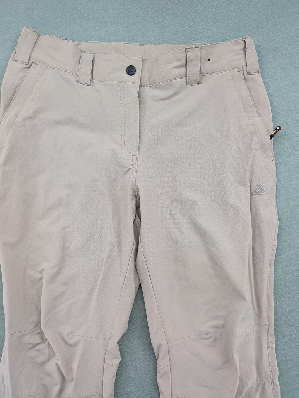 Hickory beige outdoor pants with multiple zippered pockets and stretch fabric for comfort.