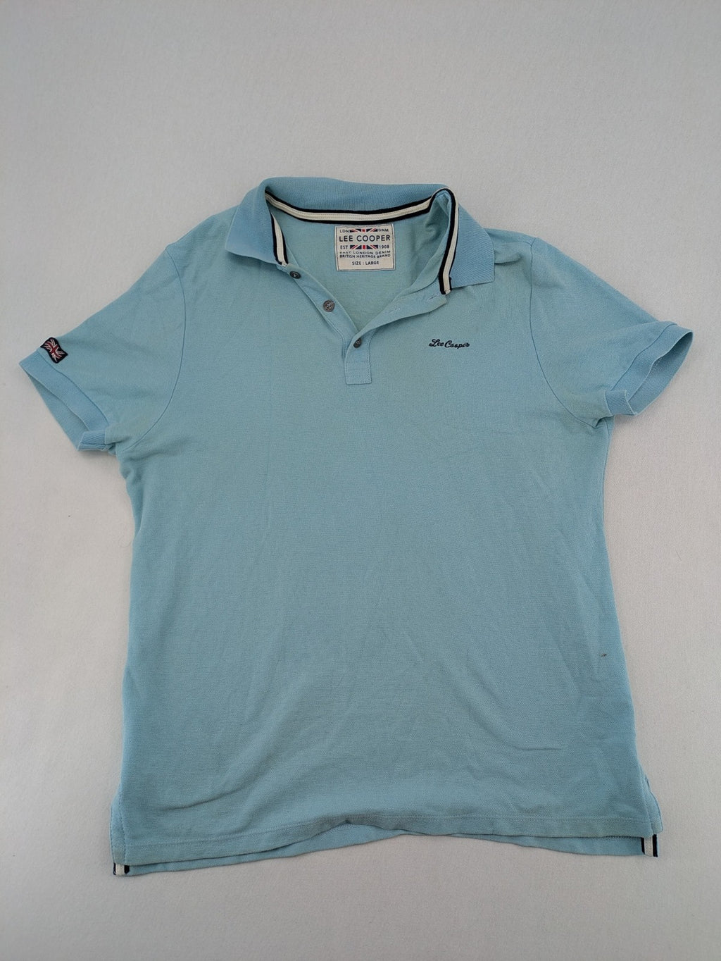 Lee Cooper blue polo shirt with embroidered logo and Union Jack patch on sleeve.