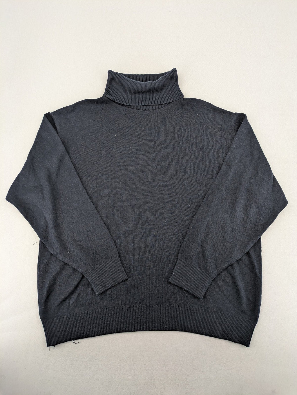 Dinovo grey knit jumper with ribbed roll neck and cuffs, made from merino wool blend.
