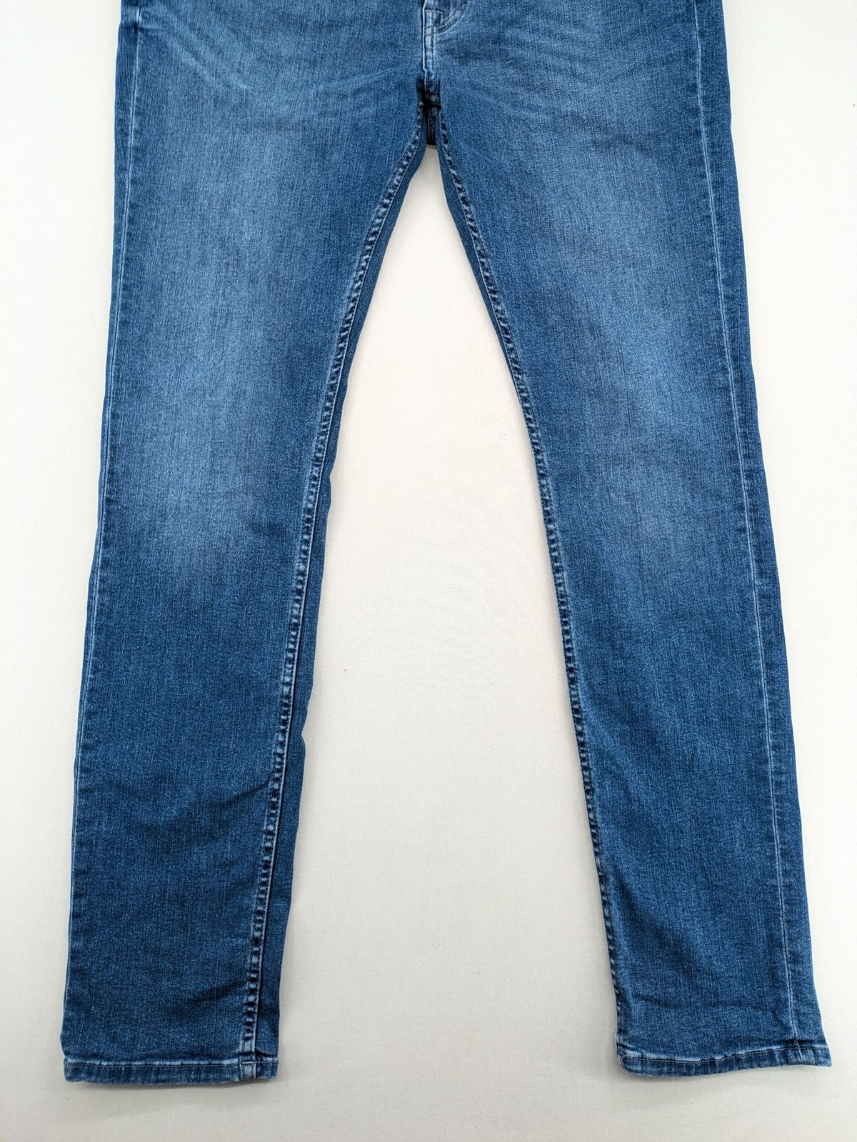 7 For All Mankind blue straight jeans with 5-pocket design and logo on back pocket.