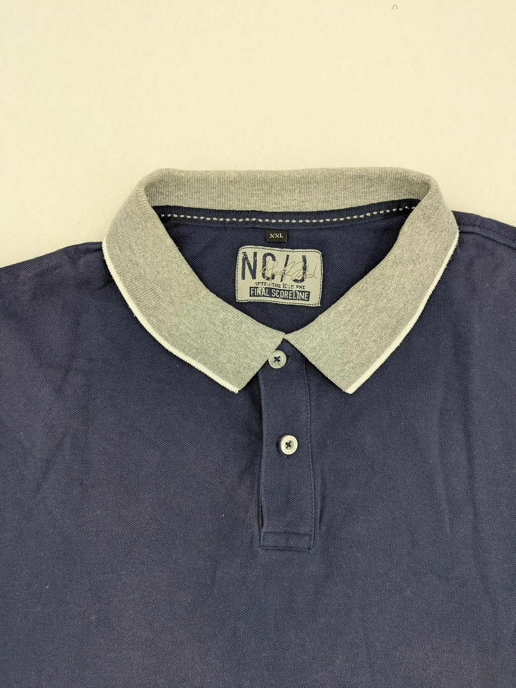 XXL navy polo shirt with grey contrast collar and cuffs, 100% cotton material.