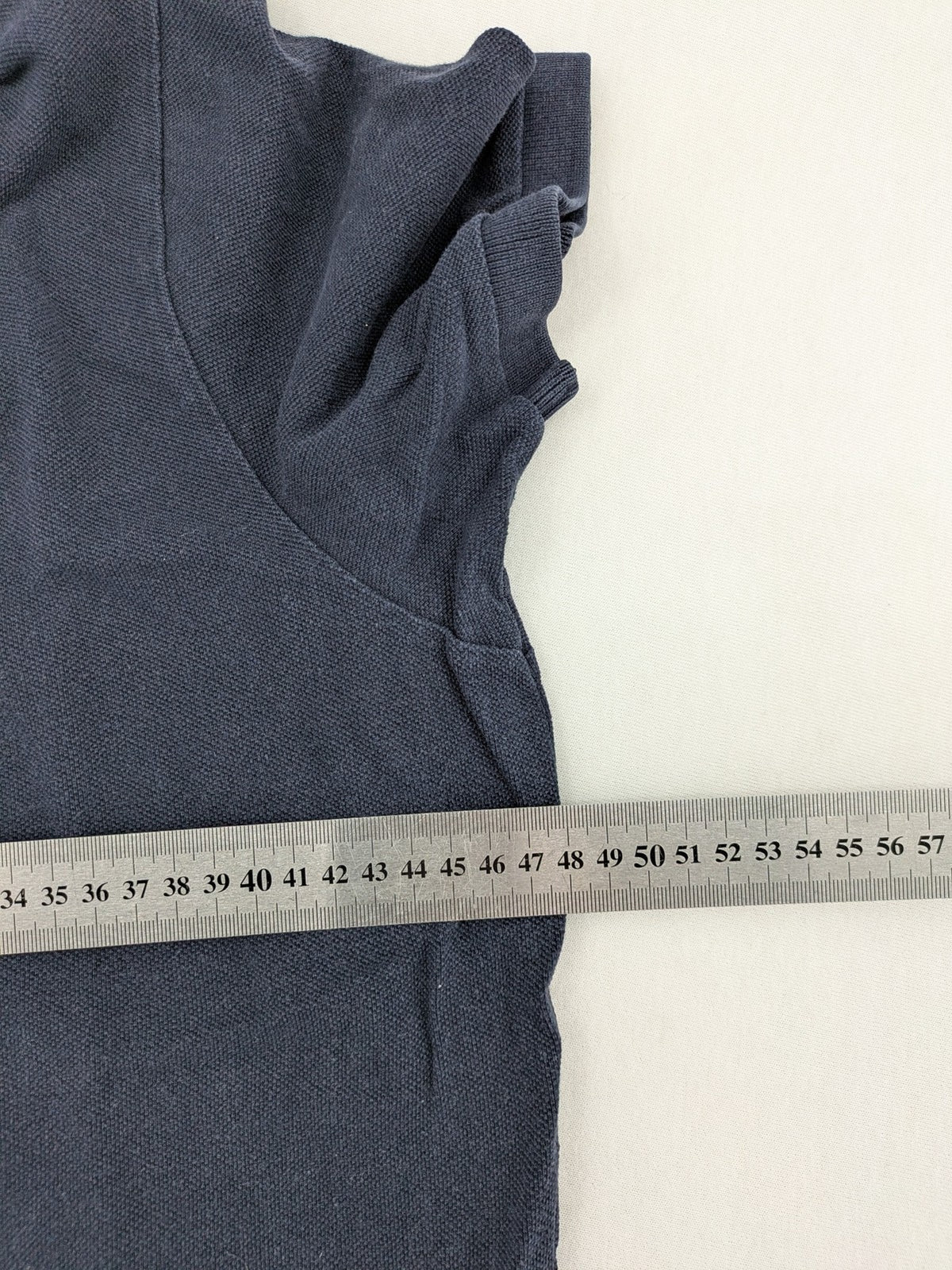 Hollister navy polo shirt with embroidered seagull logo and classic collar.