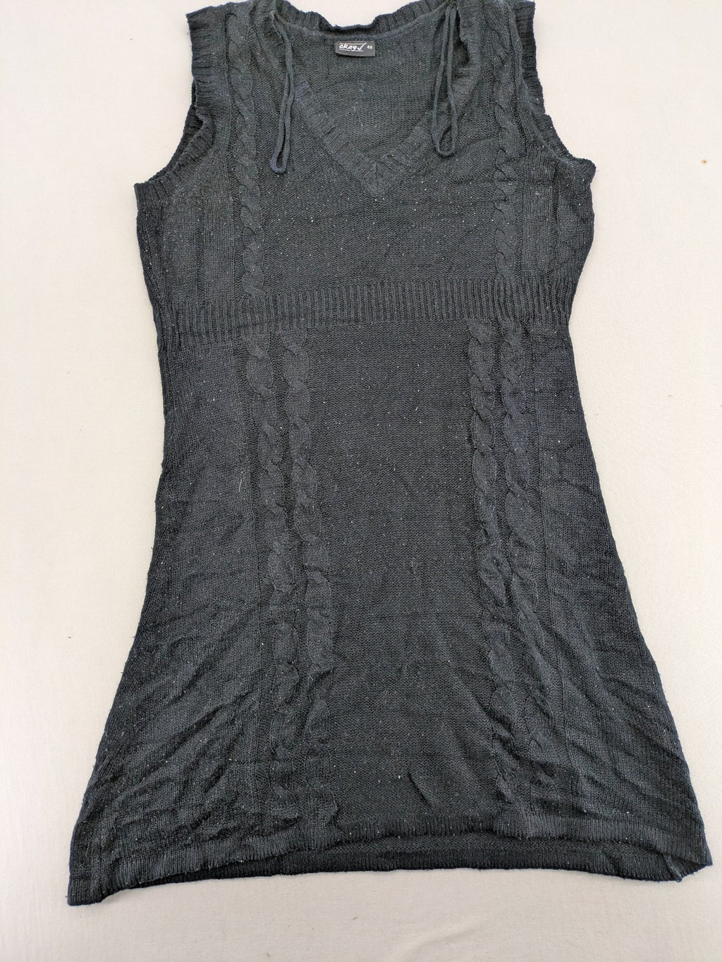 Okay black sleeveless dress V-neck with decorative cord and cable knit pattern.