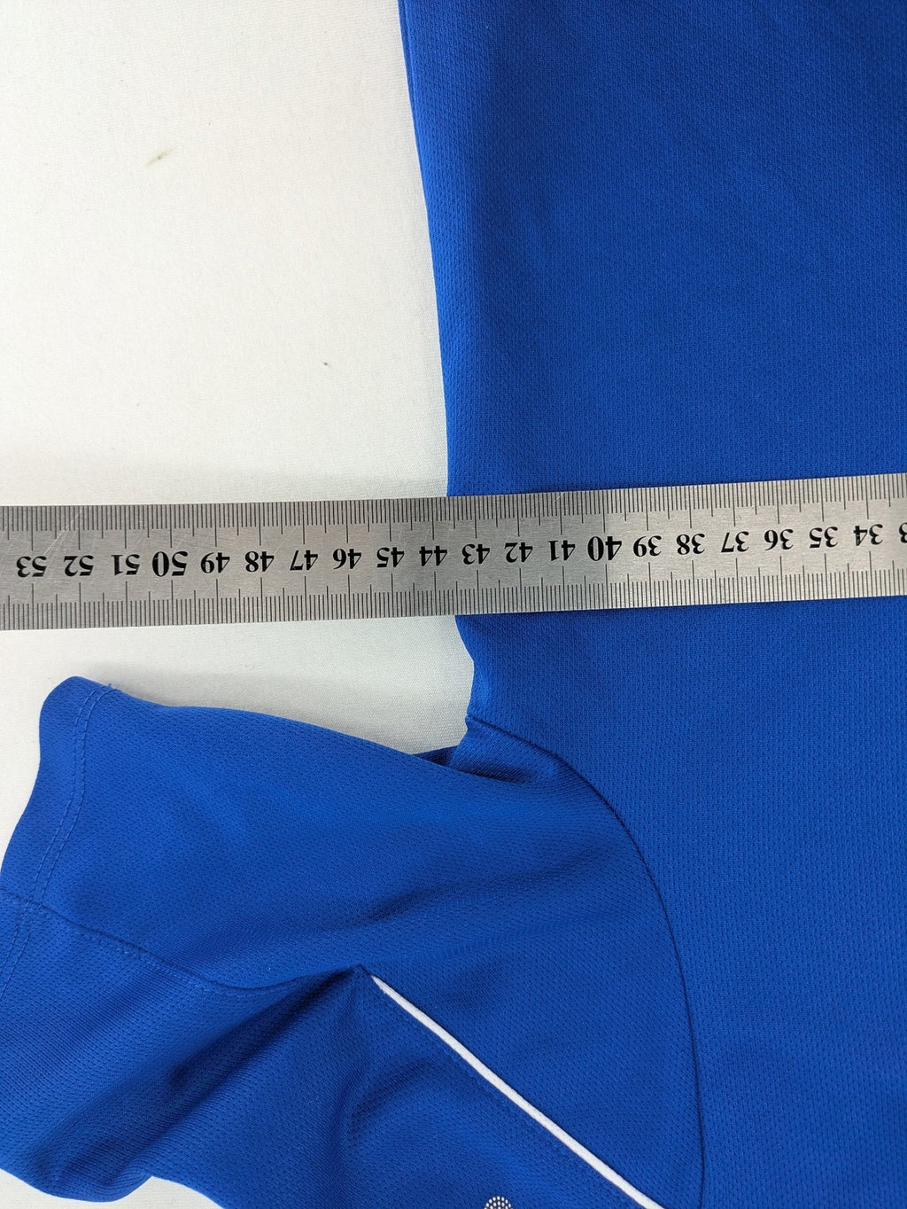 Jako blue short-sleeve training shirt with logo details and breathable polyester material.