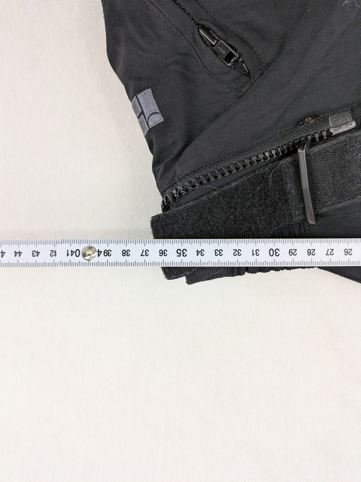 iXS black chaps with grey accents, waterproof textile, adjustable belt, reinforced knees.