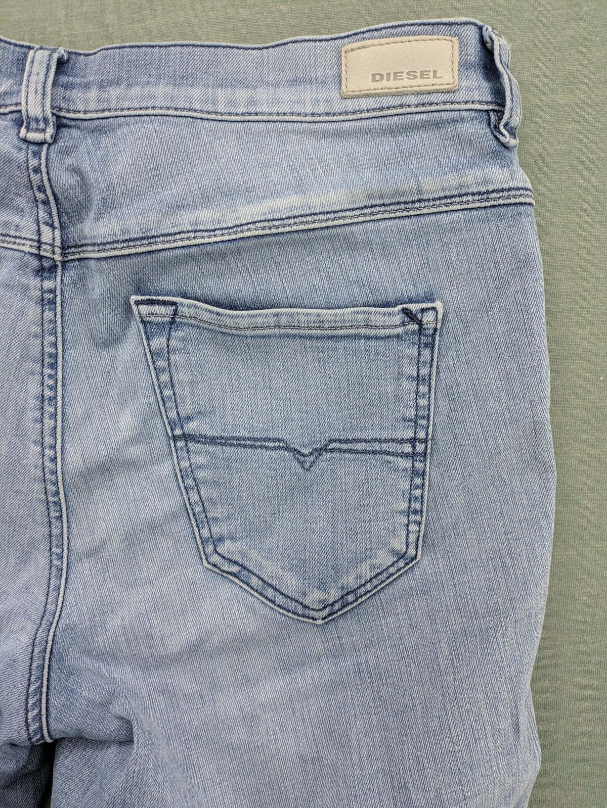 Diesel blue bootcut jeans with white patch pockets and regular waist, stylish stretch material.