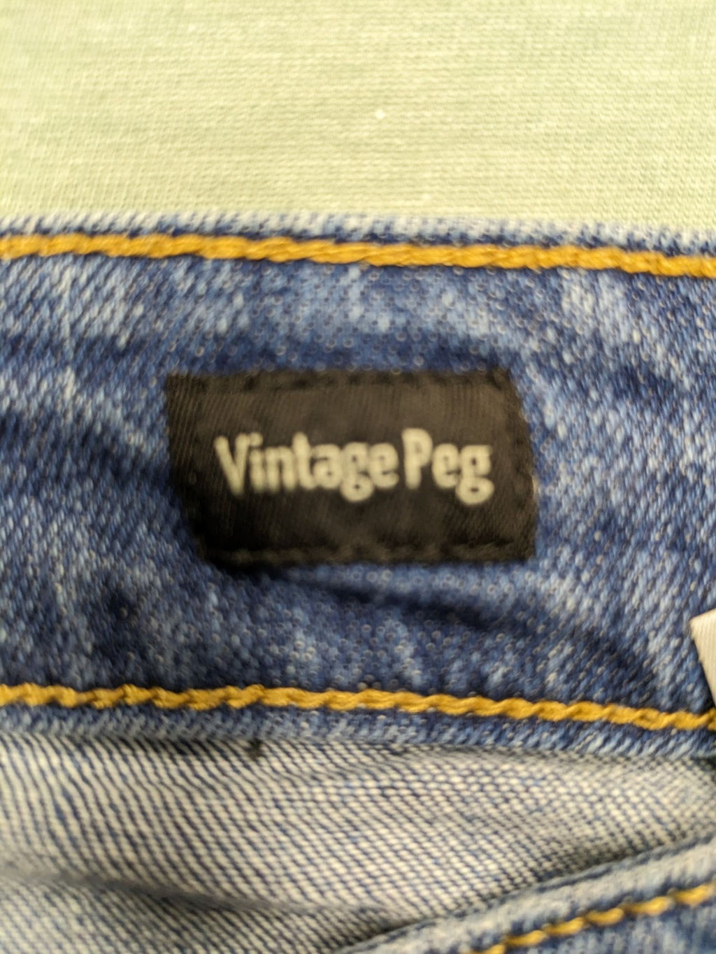 Peg blue ripped straight jeans with distressed details and comfortable stretch material.