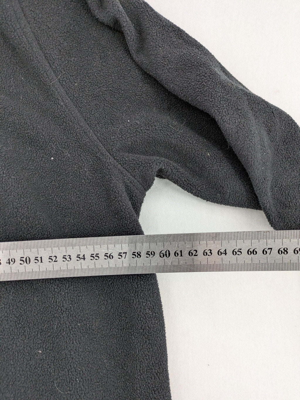 Crane beige and black fleece jacket full zip with cream accents and zippered pockets.