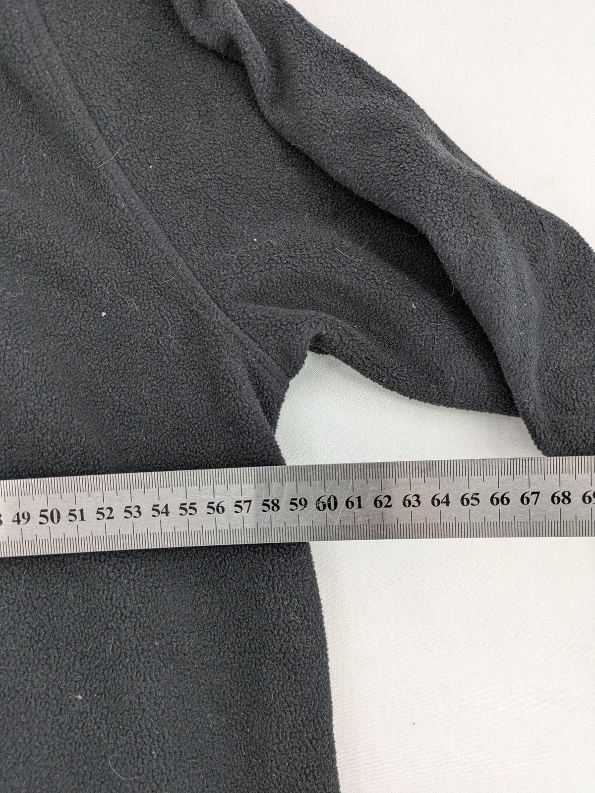 Crane beige and black fleece jacket full zip with cream accents and zippered pockets.