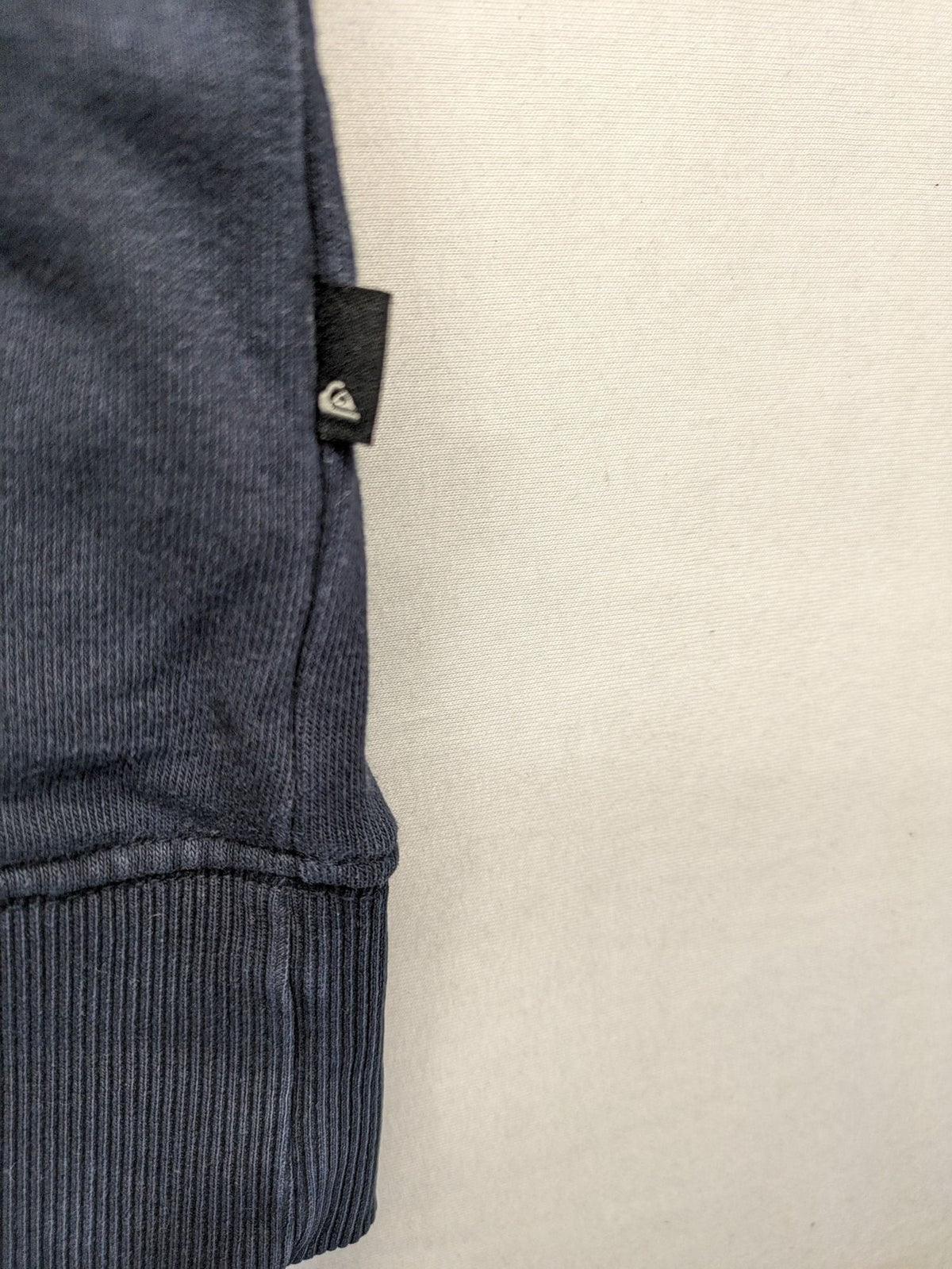 Quiksilver grey hoodie with logo graphic, kangaroo pocket, and adjustable hood.