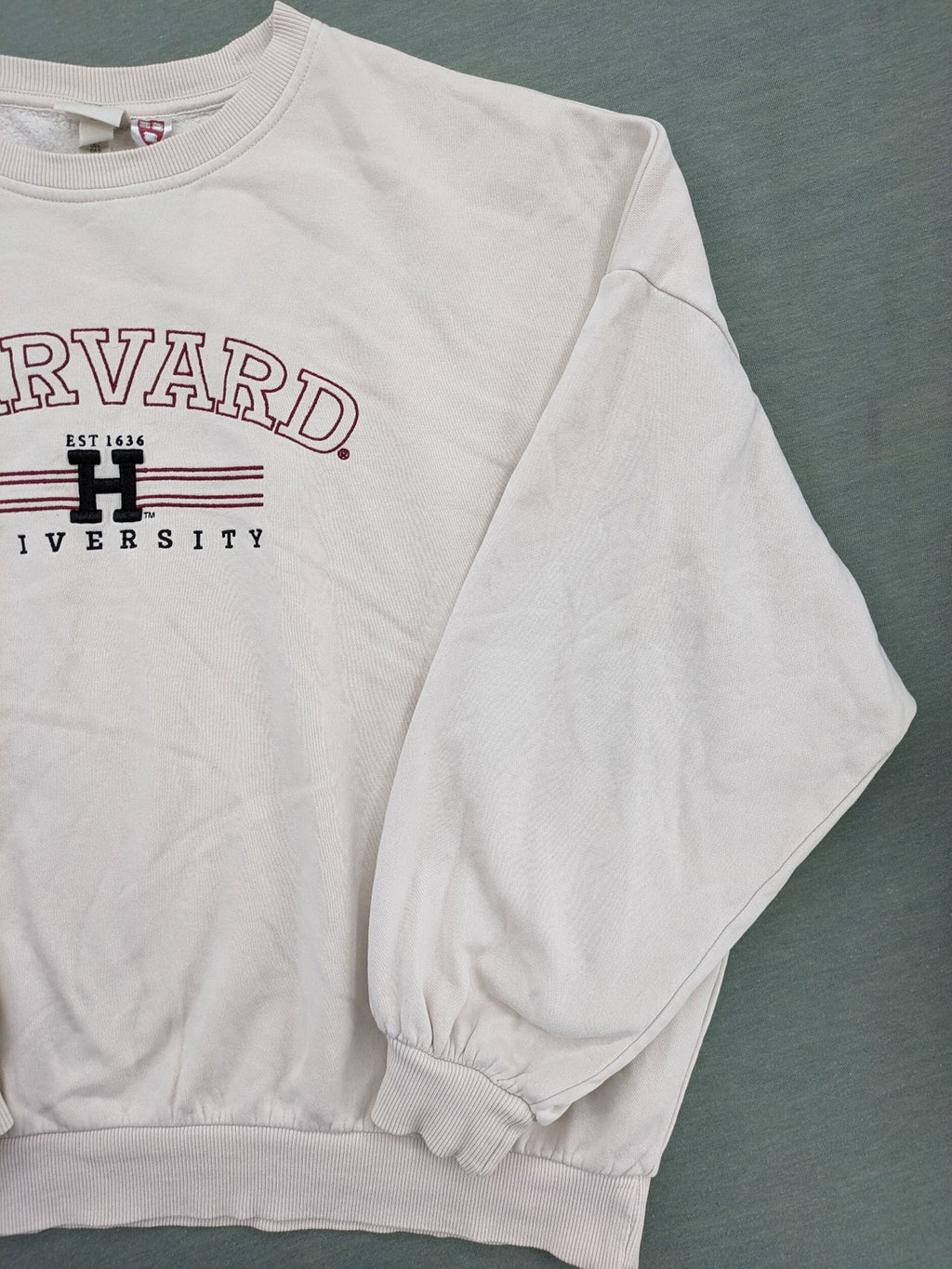H&M cream turtle neck jumper embroidered Harvard University logo, soft cotton blend.