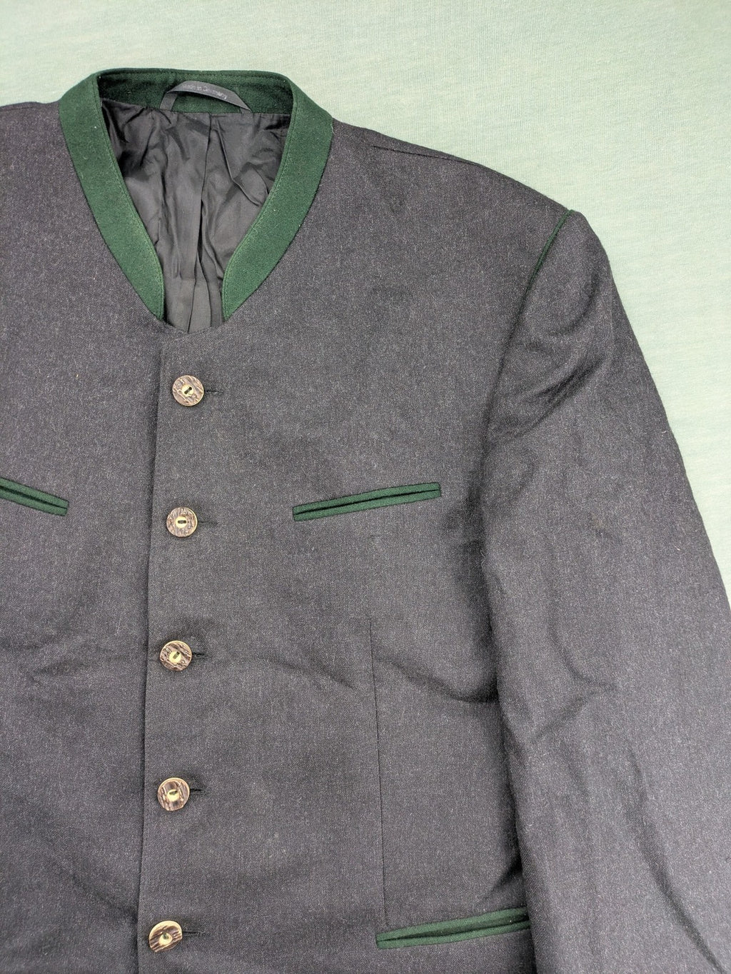 Rofan Tracht grey jacket with green stand-up collar and pockets, made from 100% wool.