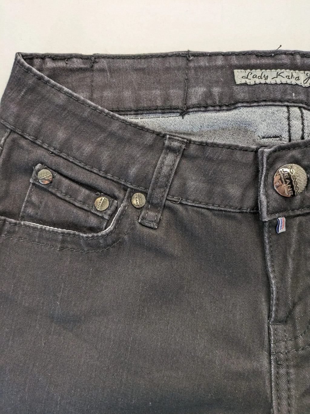 L & K Kaha black straight jeans with rhinestone logo patch and classic 5-pocket design.