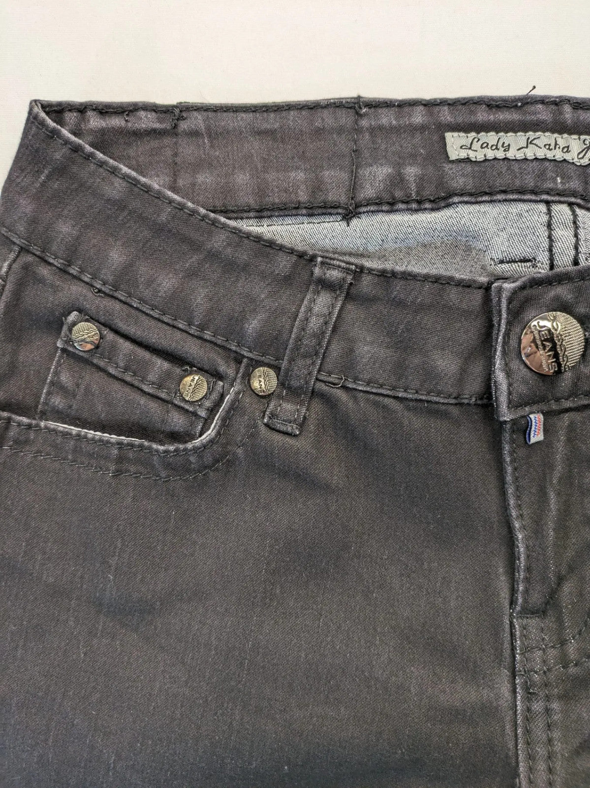 L & K Kaha black straight jeans with rhinestone logo patch and classic 5-pocket design.
