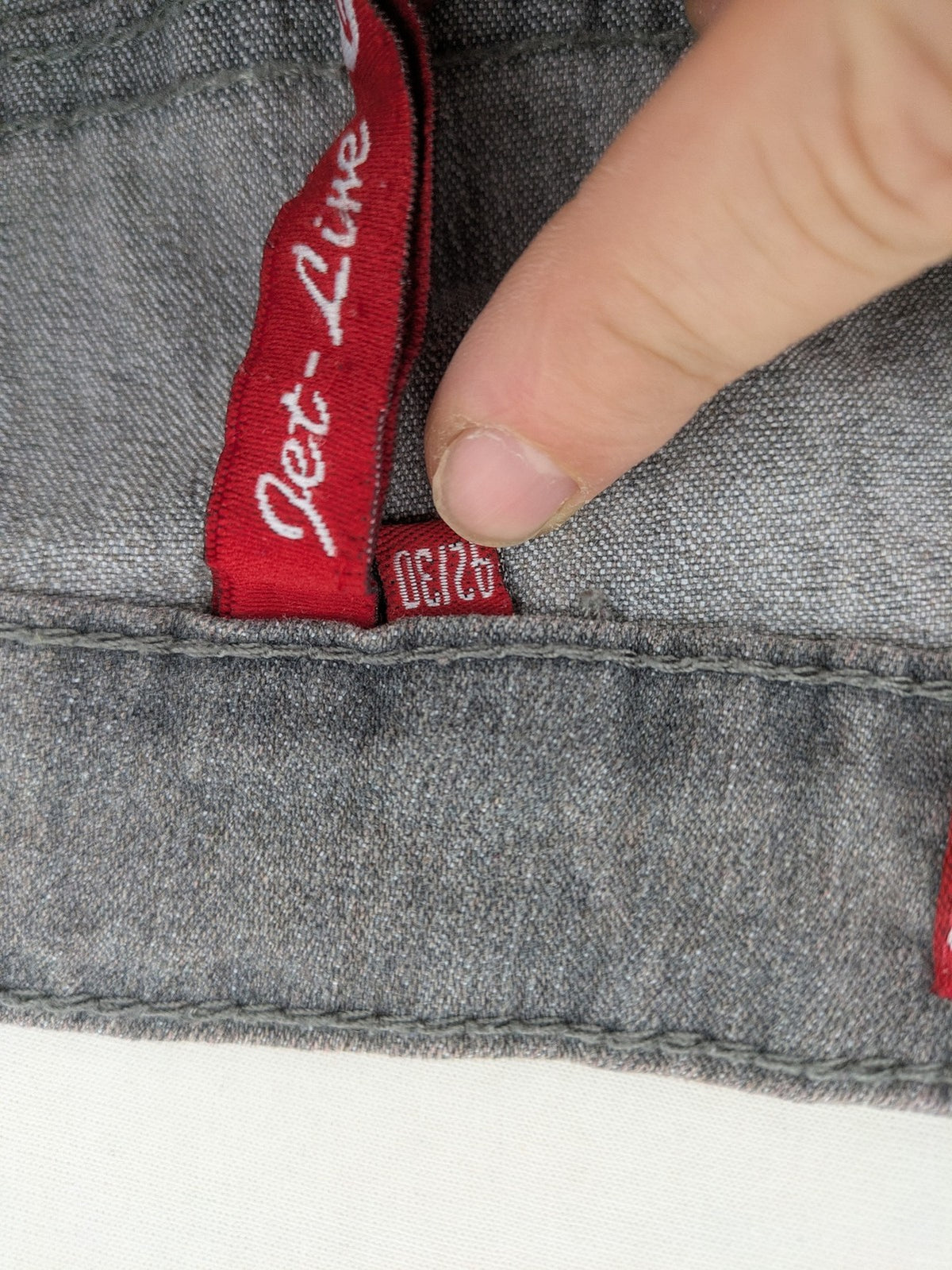 Jet Line grey straight jeans with embellished back pockets and frayed hem details.
