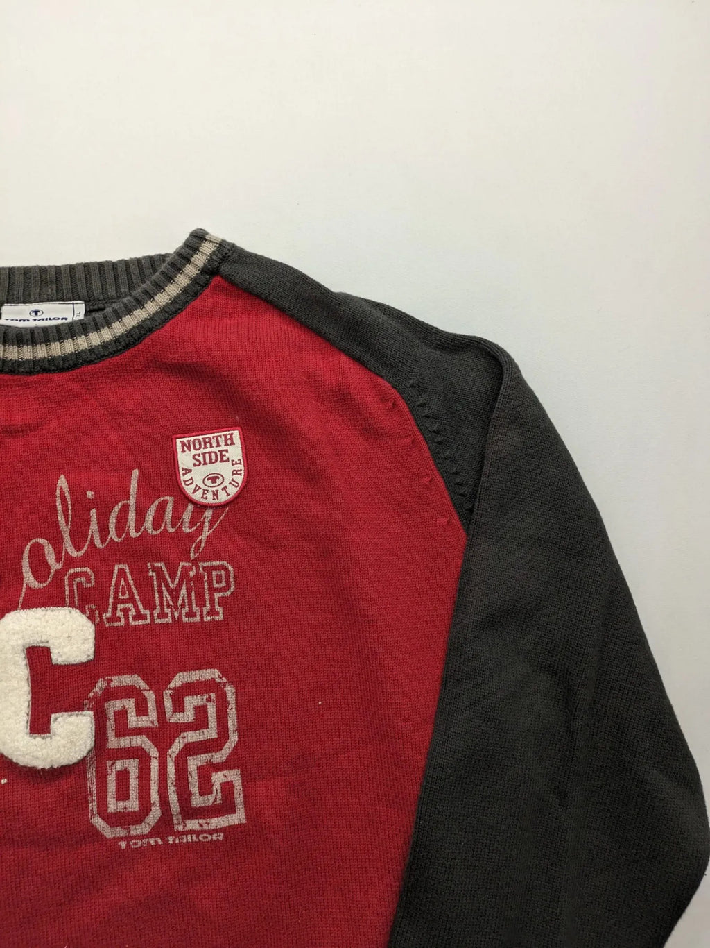 Tom Tailor black and red turtle neck jumper with "Holiday Camp" chenille patch and striped cuffs.