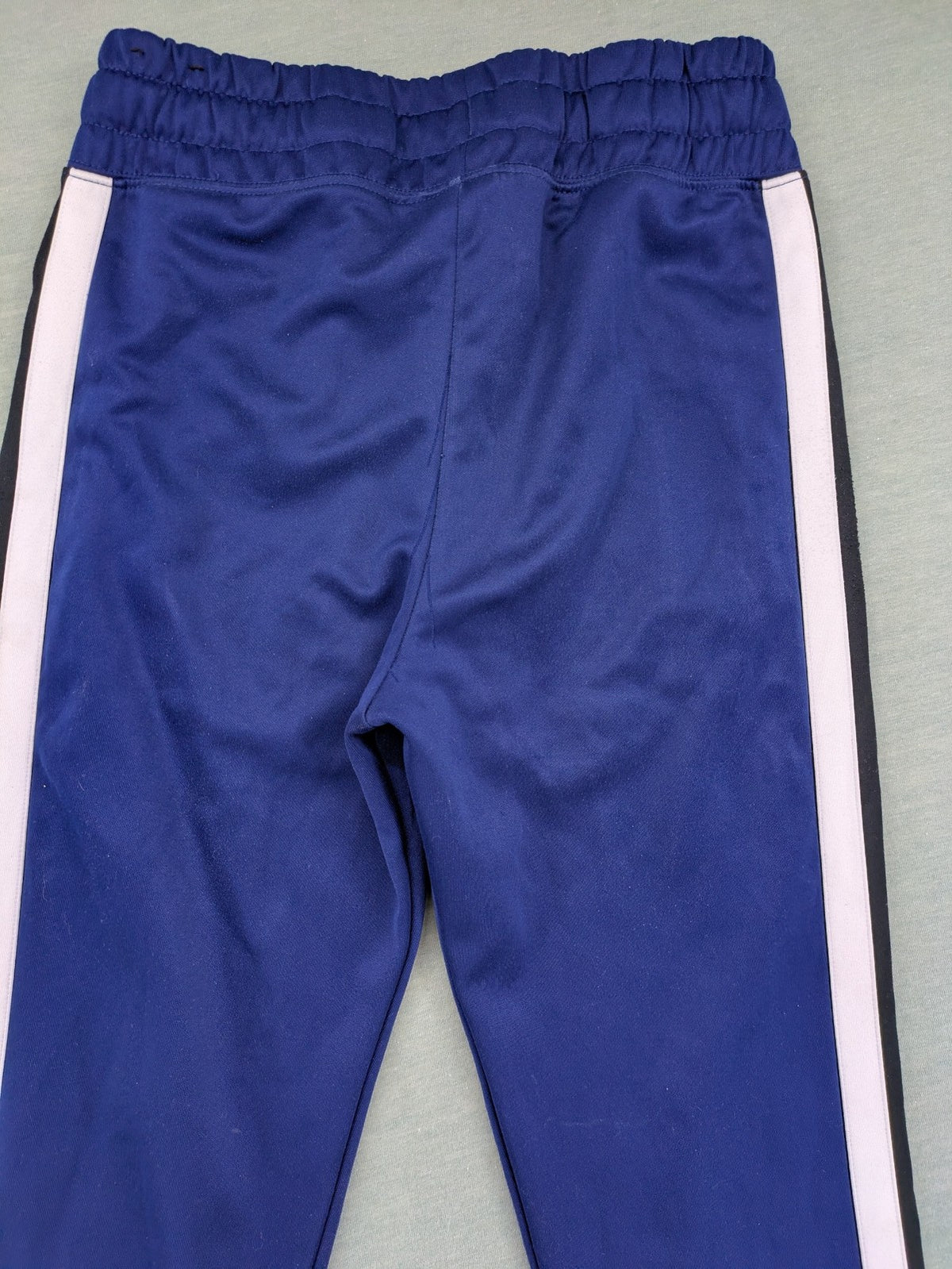 Nike Air blue jogging pants with black and white side stripes, elastic waistband.