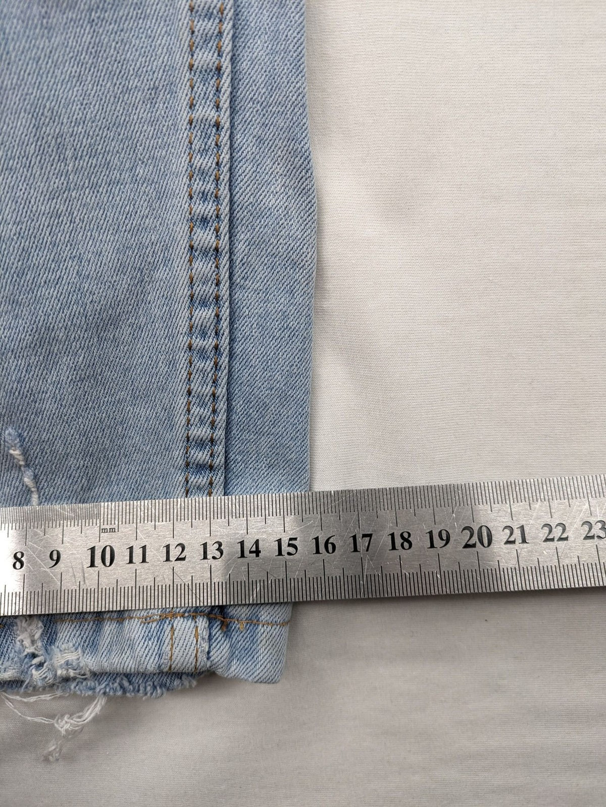 i8 Denim blue straight jeans destroyed look with frayed hems and classic button fly.