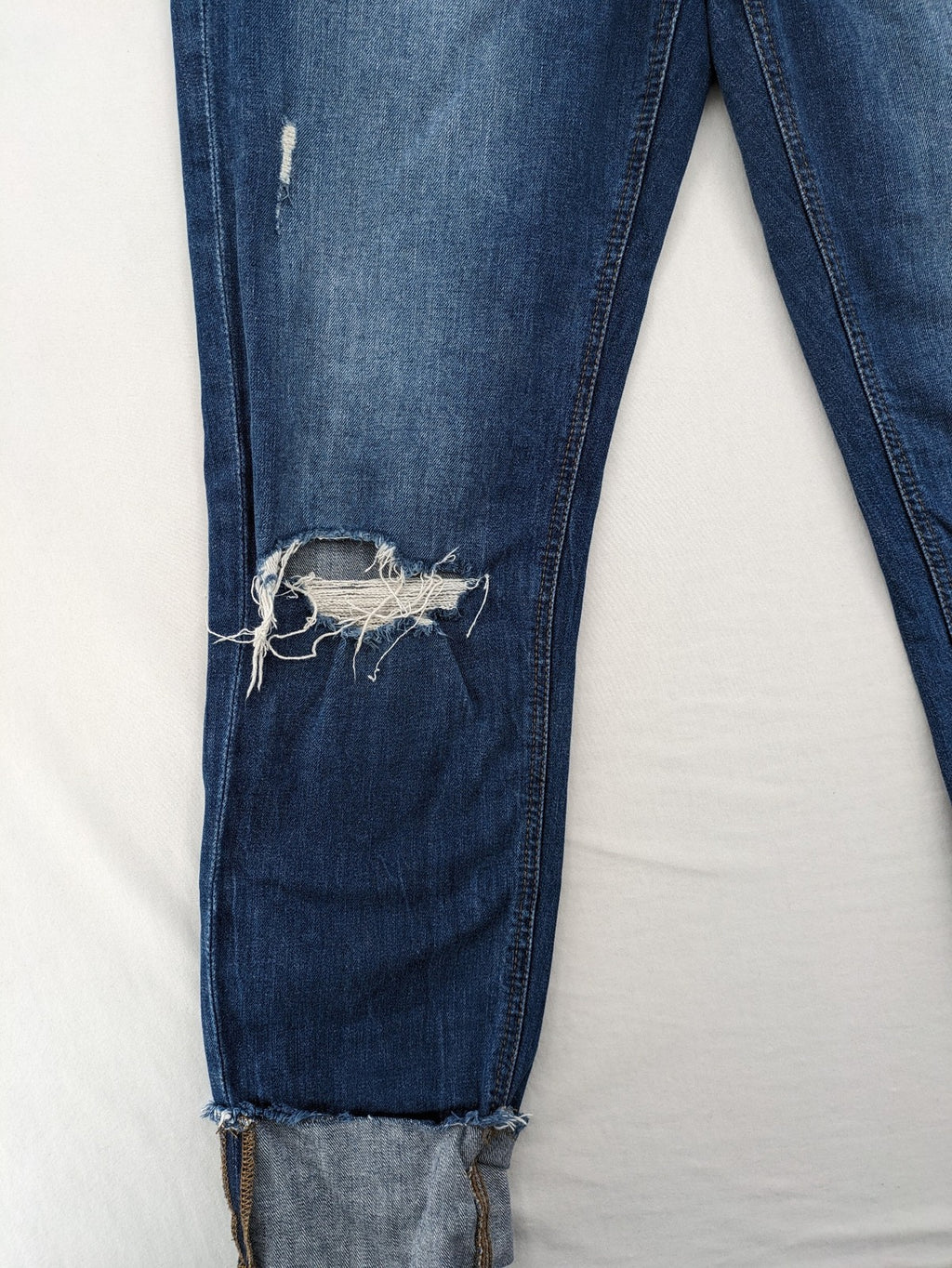 Esprit blue straight leg jeans with ripped knee details and rolled hem.