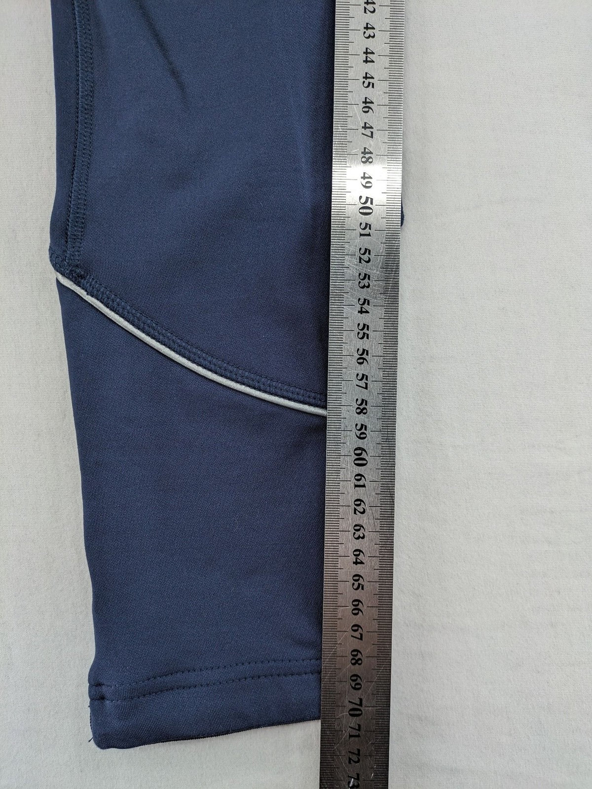 Crane Sports navy running tights with reflective details and zippered ankle openings.
