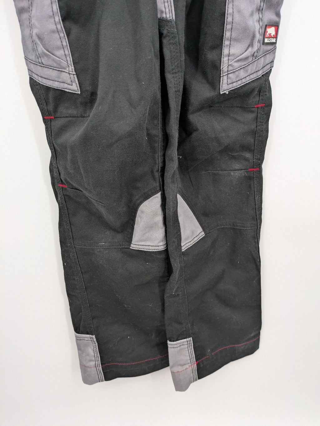 Cargo pants black grey two-tone design with red stitching and multiple pockets