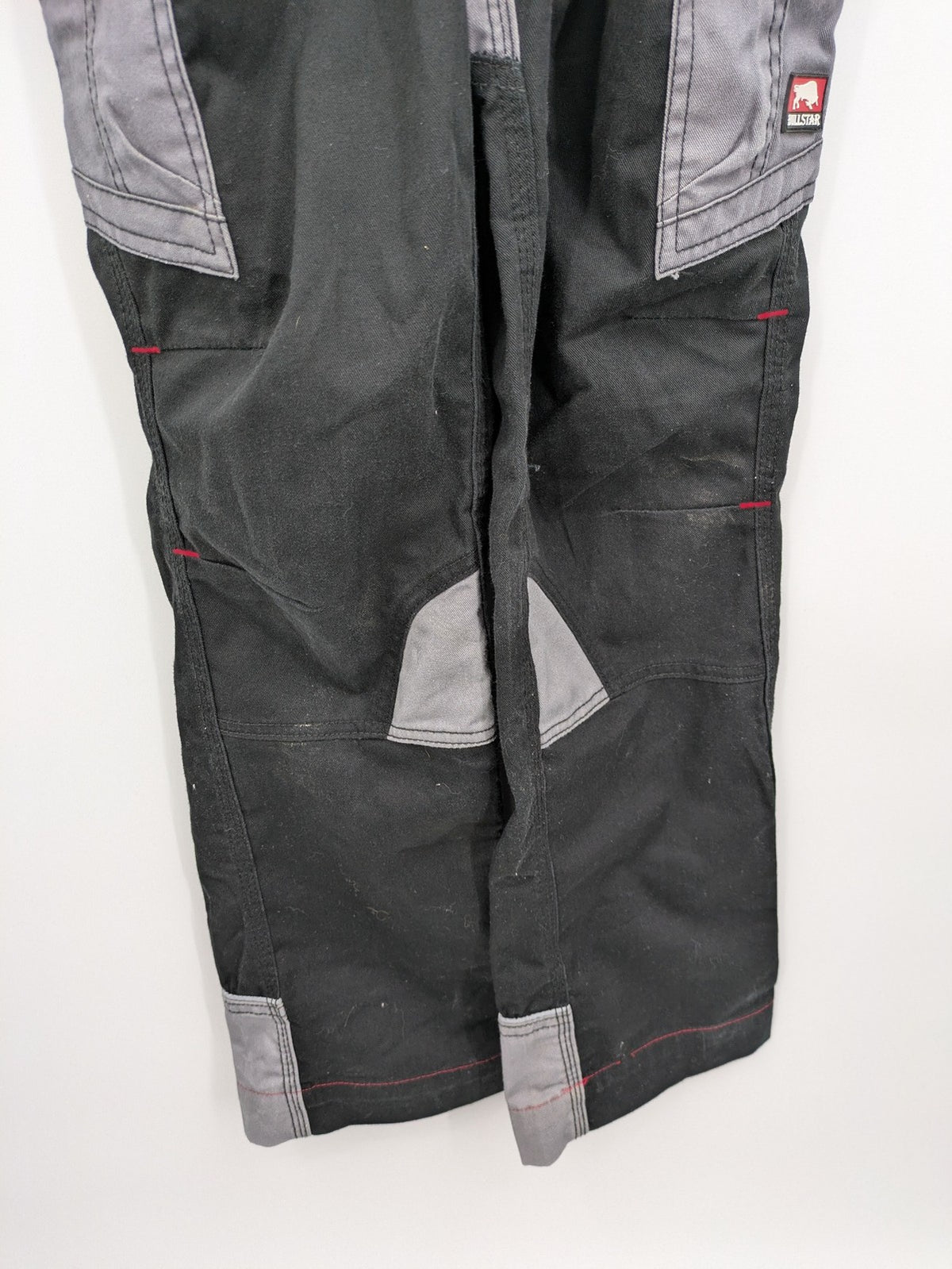Cargo pants black grey two-tone design with red stitching and multiple pockets