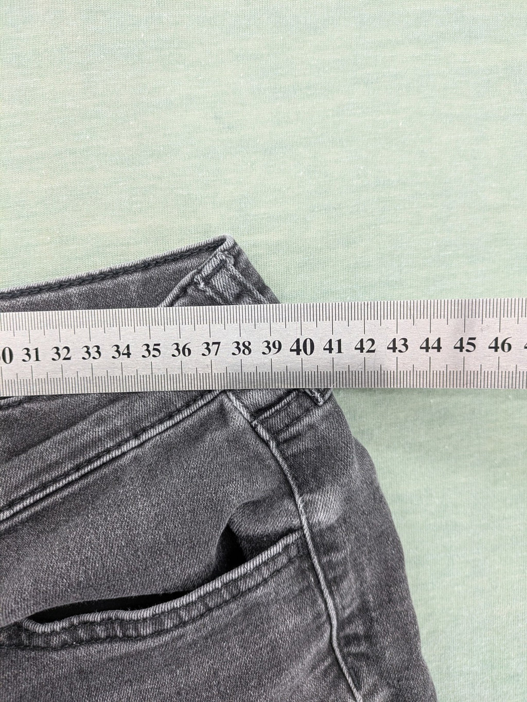 H&M grey slim fit jeans with adjustable waistband and faded wash detail.