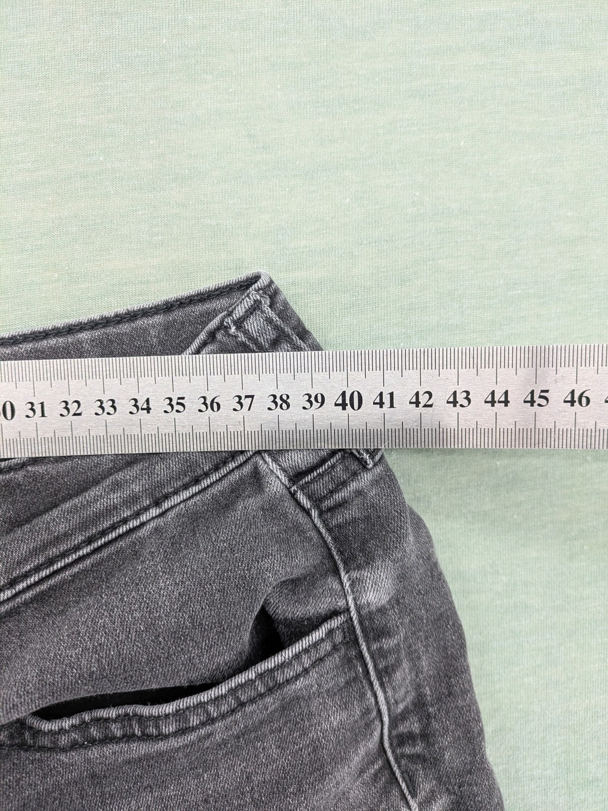 H&M grey slim fit jeans with adjustable waistband and faded wash detail.