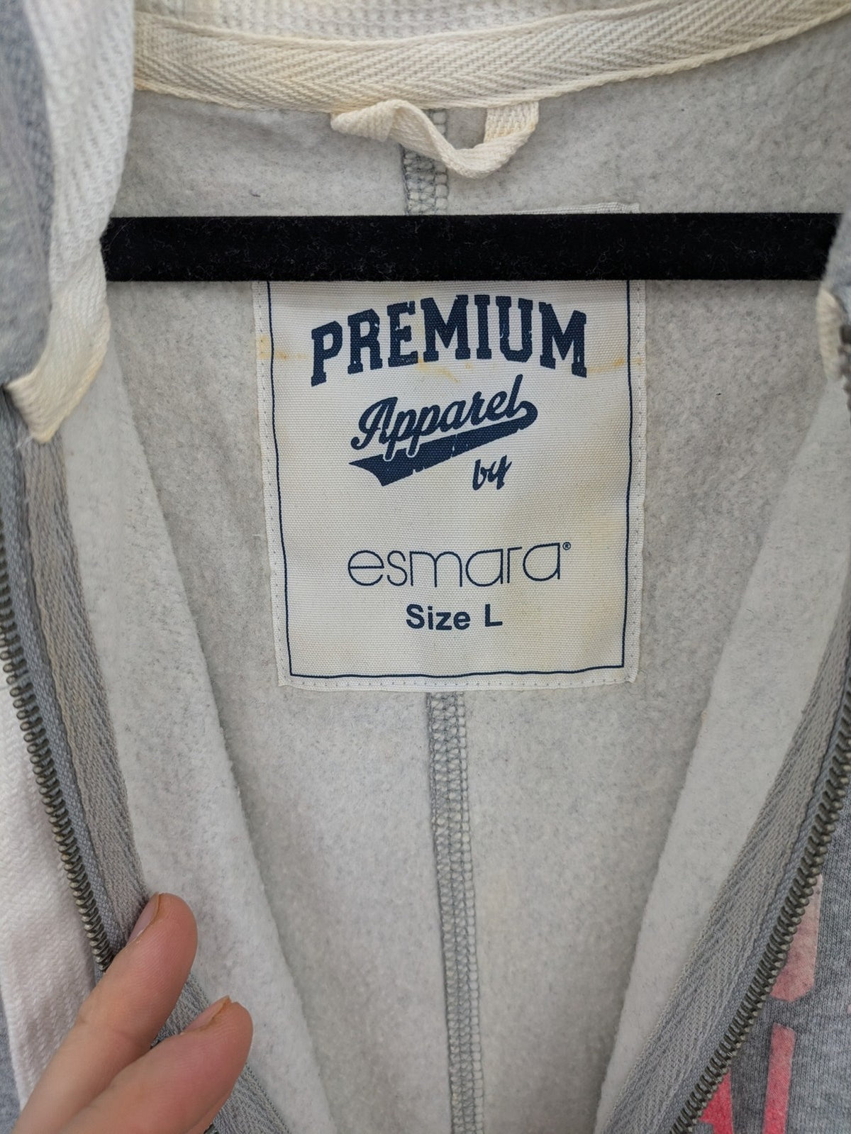 ESMARA cream jumpsuit with hood, graphic print, and front zipper, soft material.