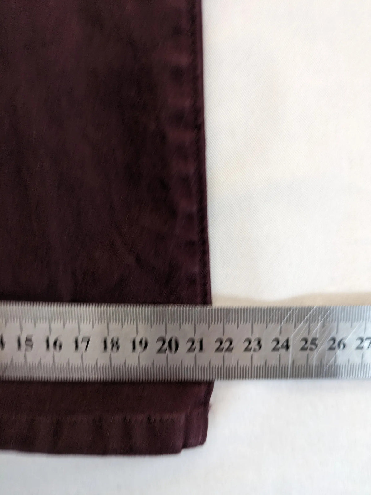 Kazane burgundy overalls with adjustable straps, side button placket, and chest pocket.