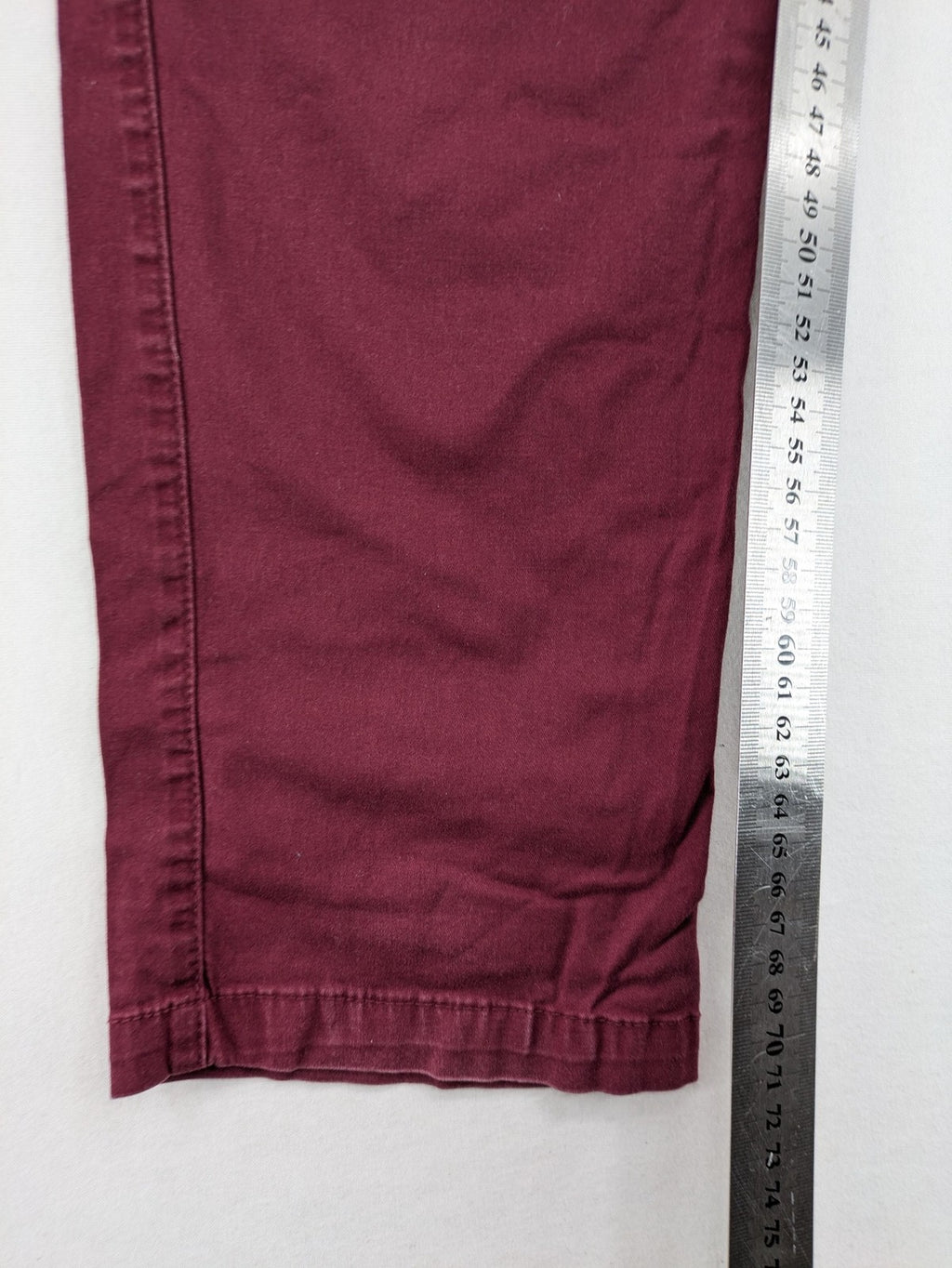 BPC Bonprix burgundy chino pants with front pleats and floral pocket lining.