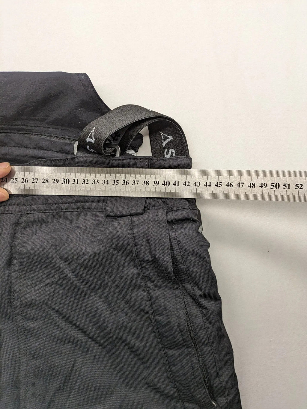 Schoffel black ski pants with adjustable straps, zip pockets, and snow gaiters.
