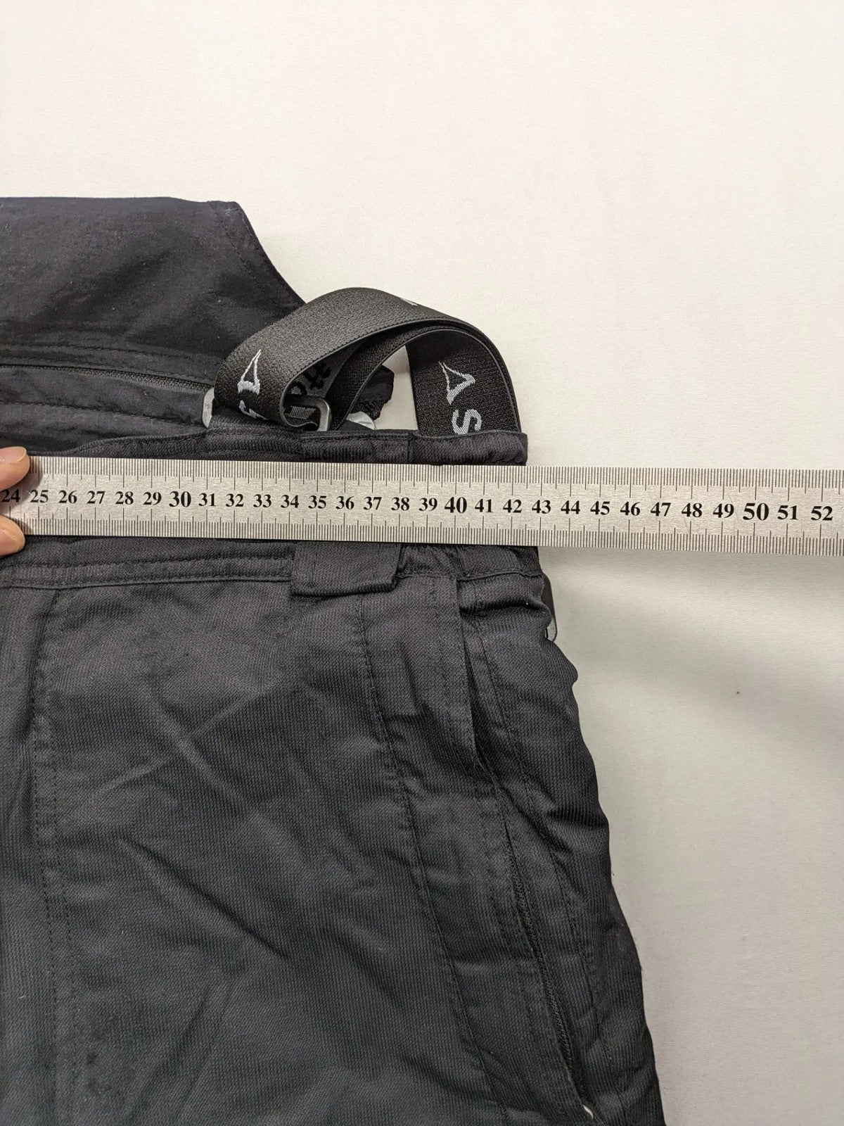 Schoffel black ski pants with adjustable straps, zip pockets, and snow gaiters.