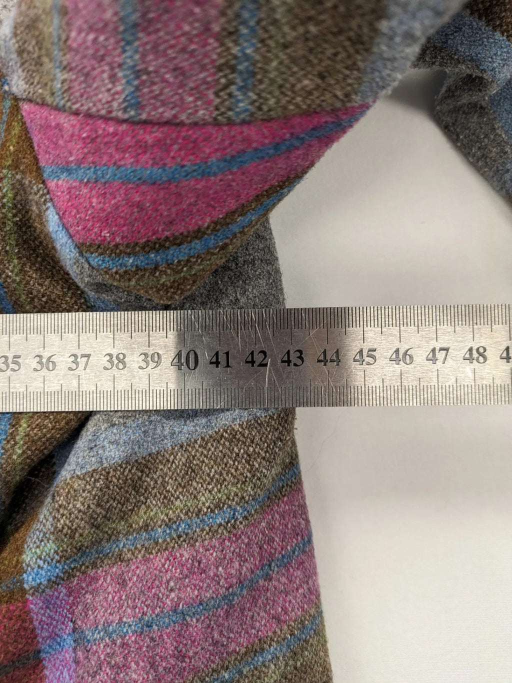 Johnnie B pink coat with gray check pattern, Sherpa lining, and zip closure.