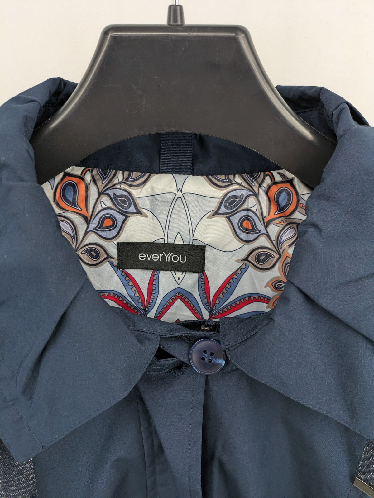 everYou navy parka jacket with hood, adjustable drawstring, patterned lining, button closure.