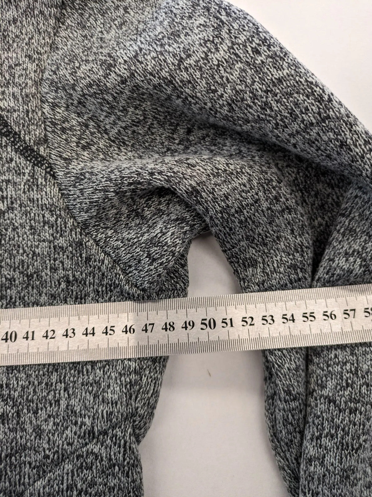 Jack Wolfskin grey fleece jacket with logo detailing and two front pockets.