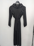 Hakke black maxi dress with ruffle details, long sleeves, and matching belt.