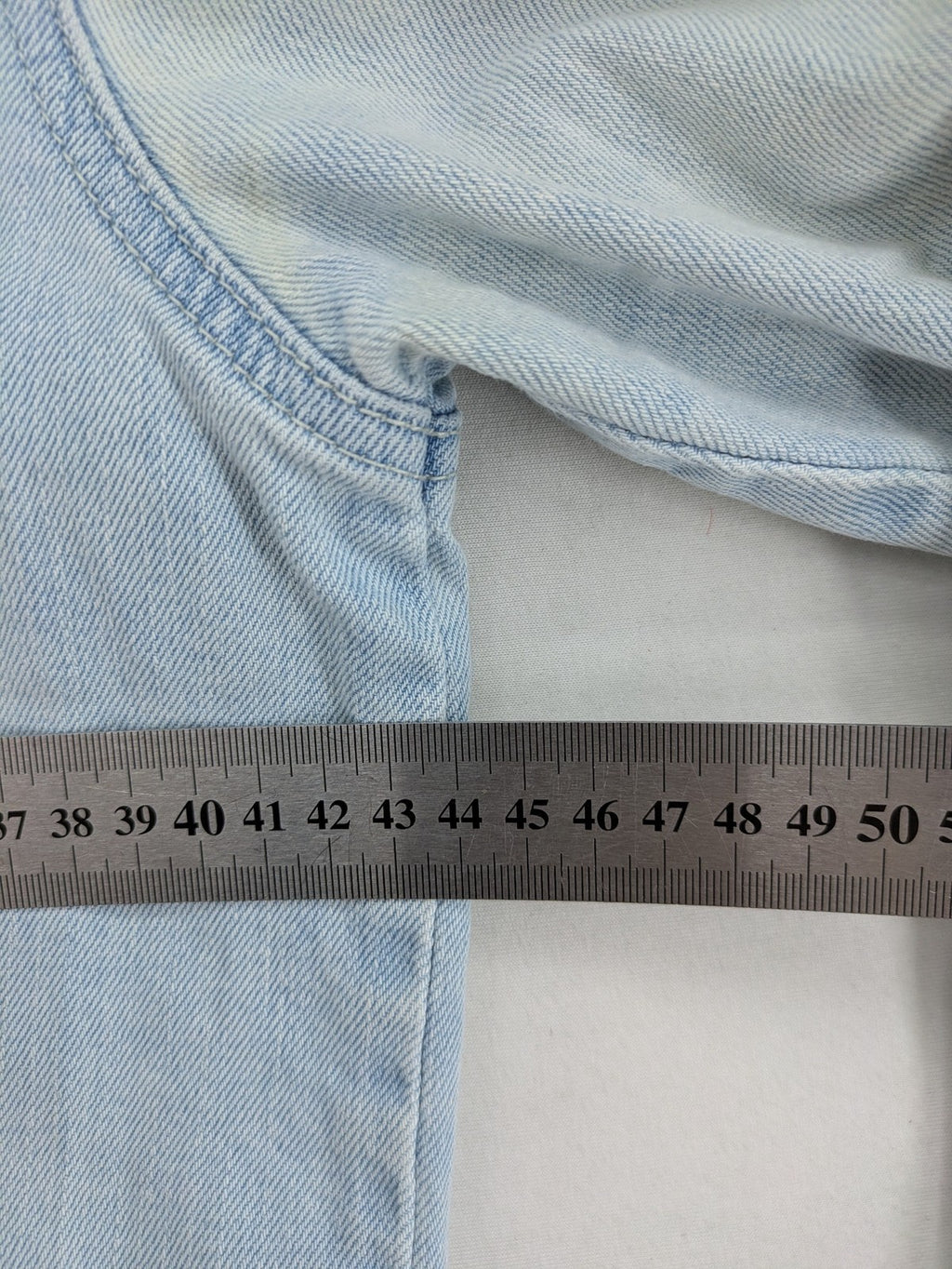 H&M denim jacket light blue classic trucker style with button placket and chest pockets.
