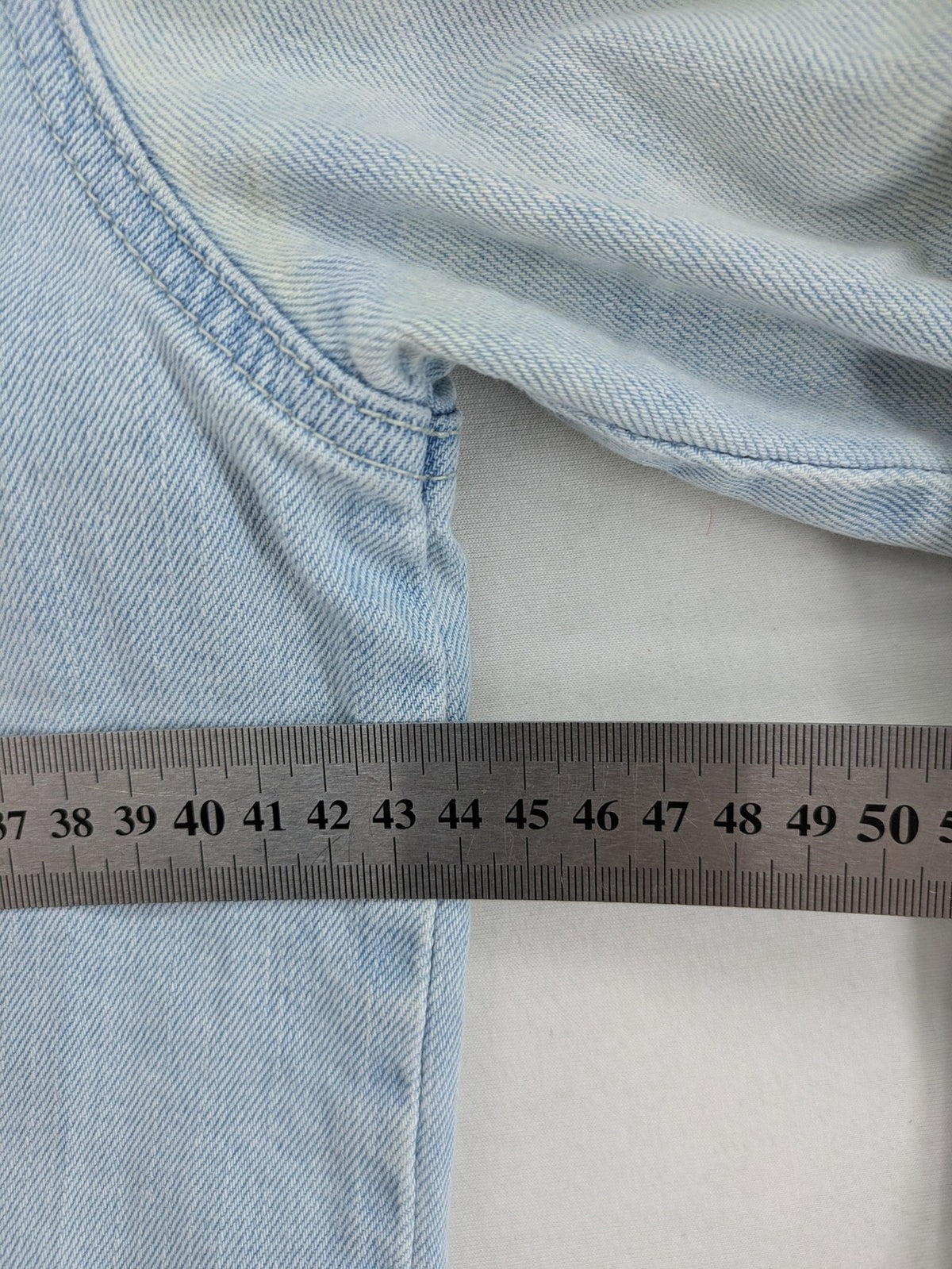 H&M denim jacket light blue classic trucker style with button placket and chest pockets.