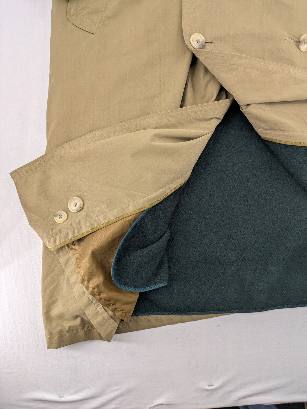 Studio Novum khaki trench coat double-breasted design with belt and wool lining.