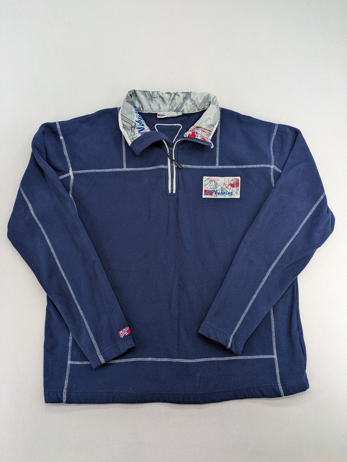 Nebulus navy turtle neck jumper with graphic print collar and "Himalaya Expedition" patch.