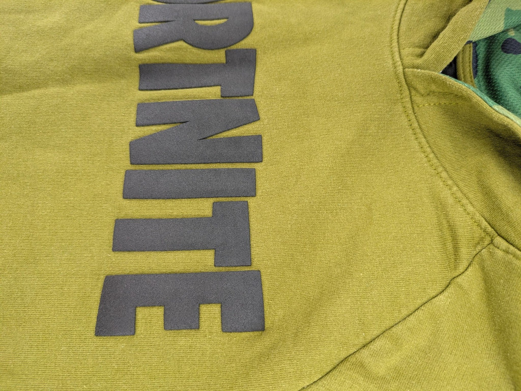 Fortnite green camo hoodie with black logo, contrasting hood, and logo taping on sleeves.