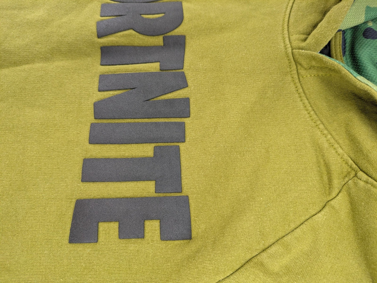 Fortnite green camo hoodie with black logo, contrasting hood, and logo taping on sleeves.