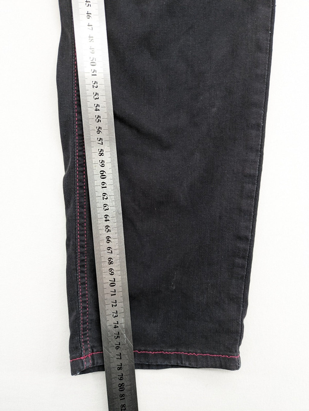 Denim black straight jeans with pink contrast stitching and classic 5-pocket style.