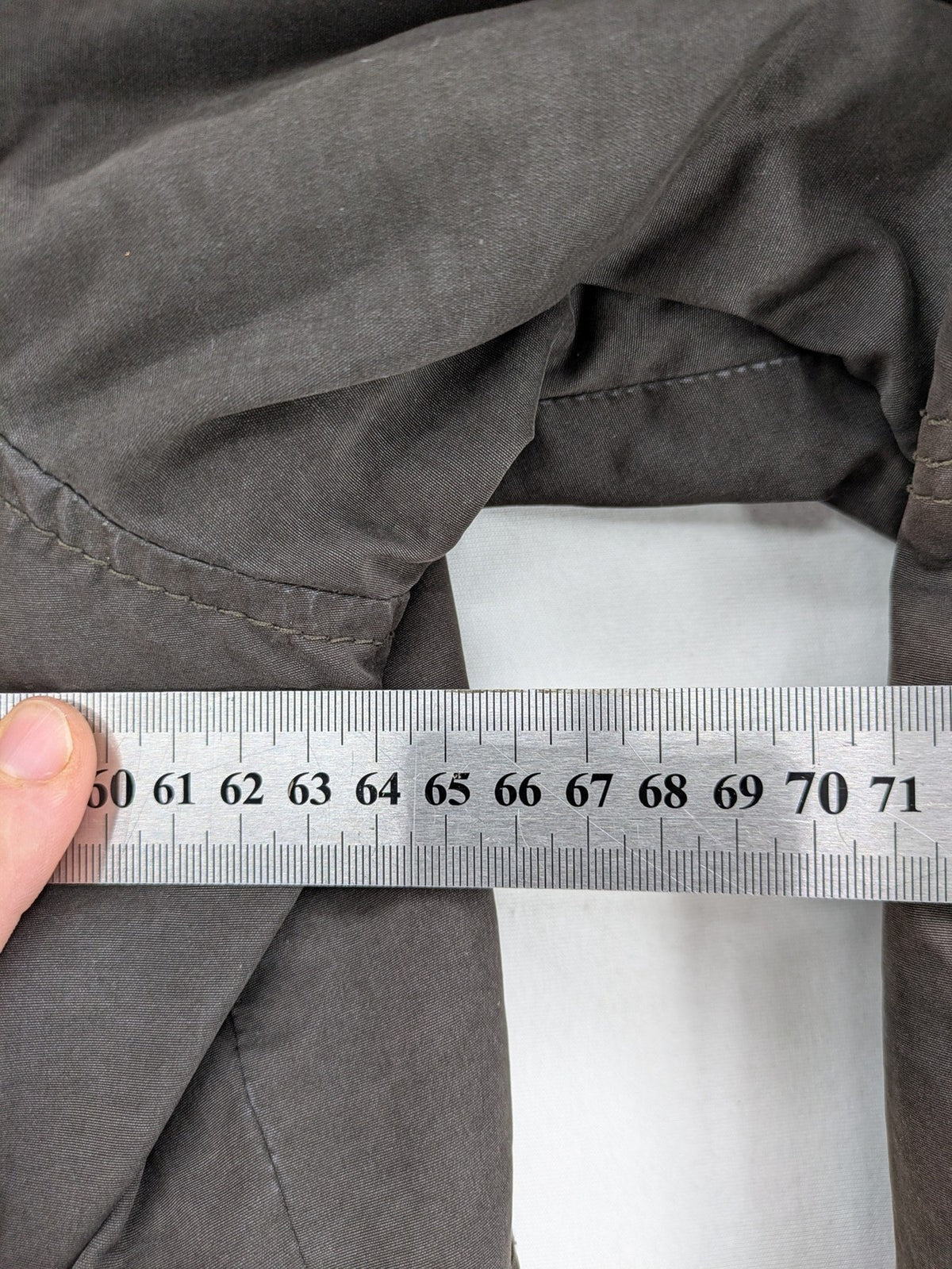 Gate One brown field jacket with plaid lining, multiple pockets, and zip-button closure.